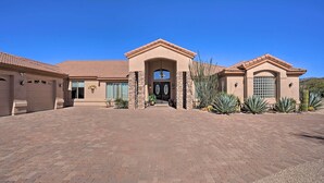 A two-story house with a central entrance, a garage, and a landscaped driveway. - Outdoor Oasis! Group-Friendly Cave Creek Retreat (Cave Creek)