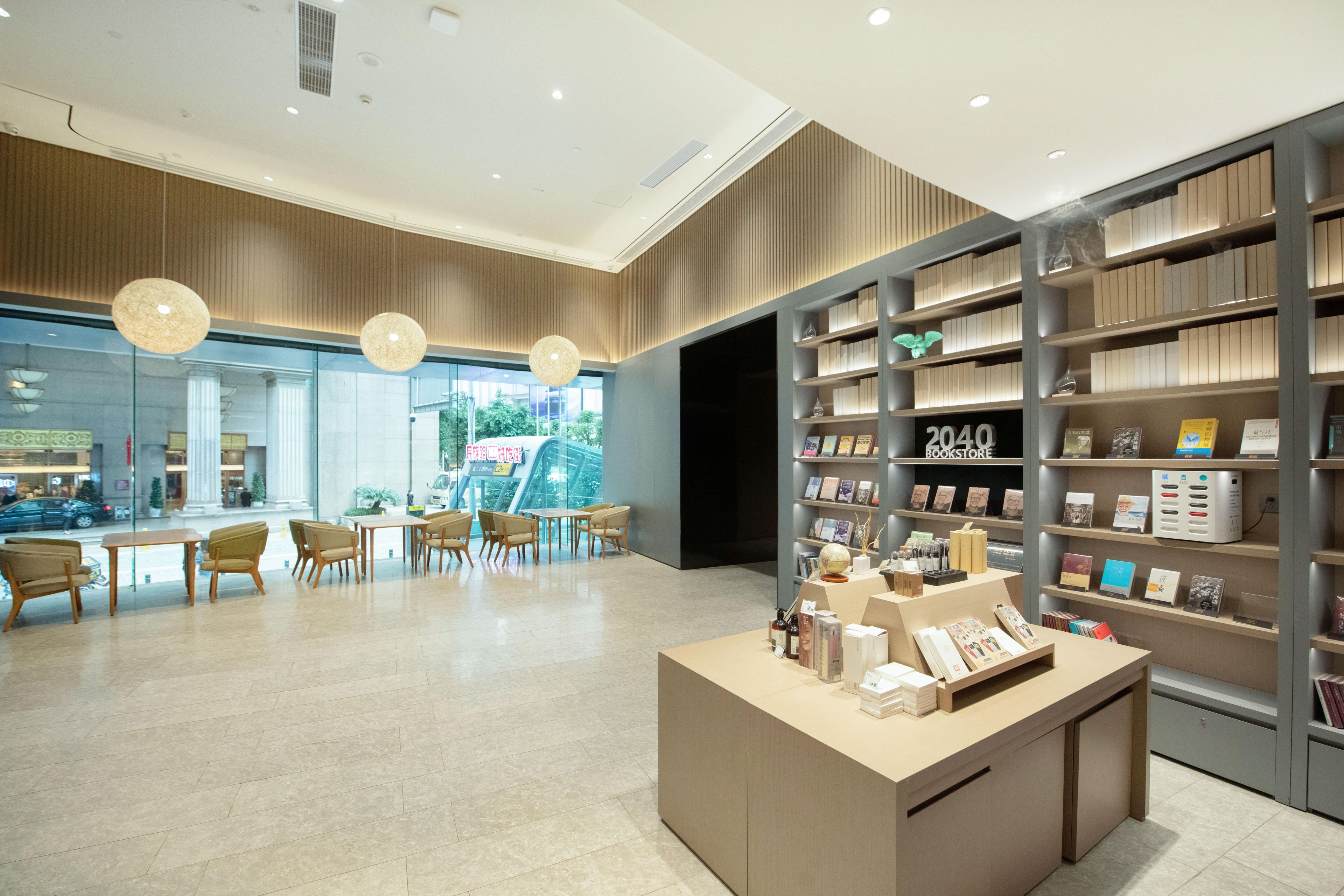 A modern interior with a reception desk, seating area, and a bookshelf labeled '2040 BOOKSTORE'.