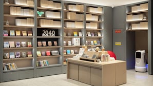 A modern bookstore with neatly organized shelves and a clean, minimalist design. - Ji Hotel (Chongqing)