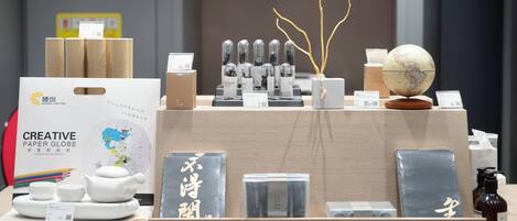 A display of various stationery items including a paper globe, a teapot, and several boxes.