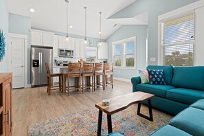 Relax in this stylish living space with a kitchen, dining area, and comfortable seating.