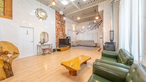 A modern living room with a wooden coffee table, green sofa, and a TV stand. - Gapyeong Ddel Poolvilla (Gapyeong)