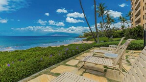 A beachfront hotel with a pool area, palm trees, and ocean views. - Oceanfront Wailea condo w/ Molokini views and pool access (Wailea)