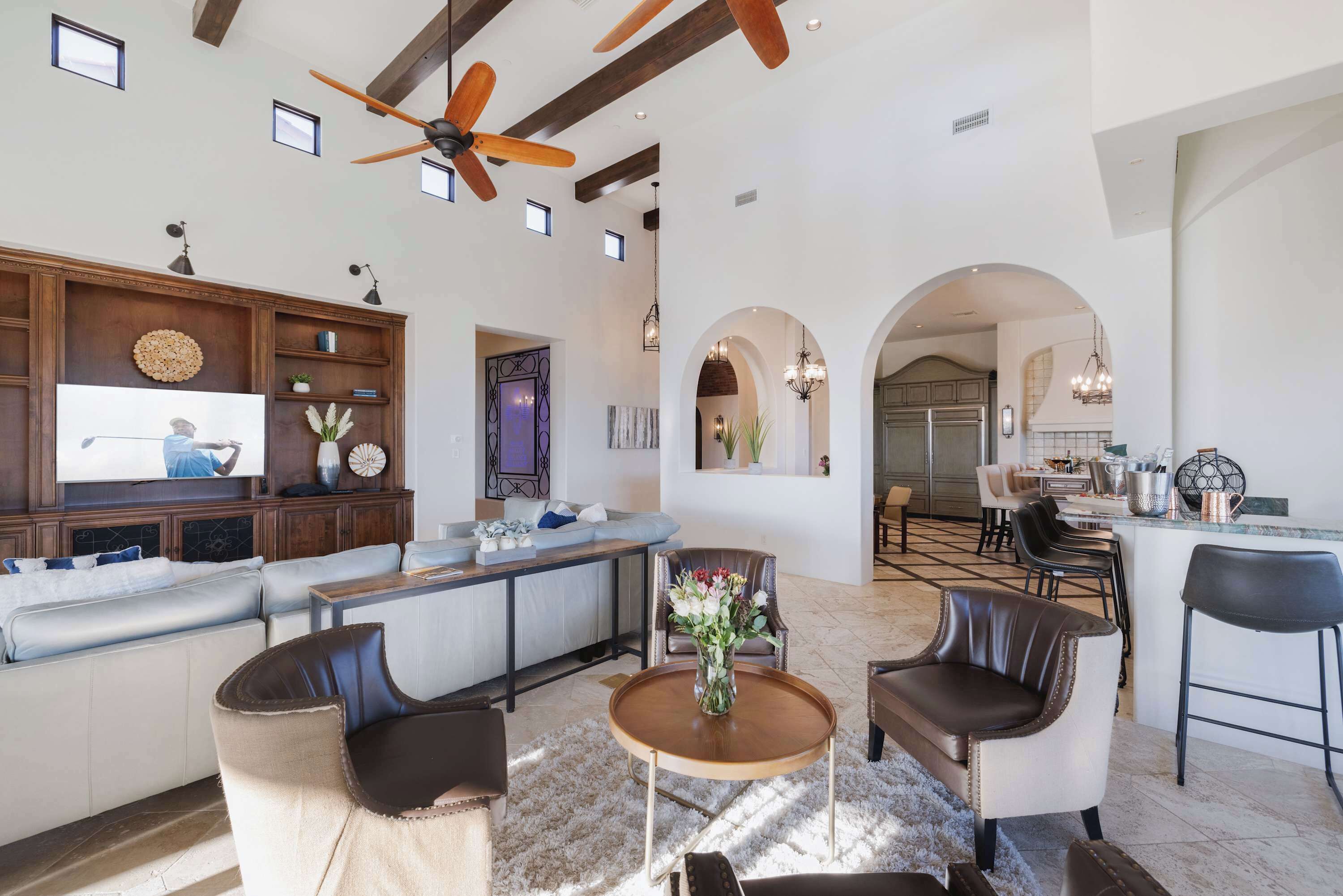 The open living and kitchen area features multiple gathering spaces,