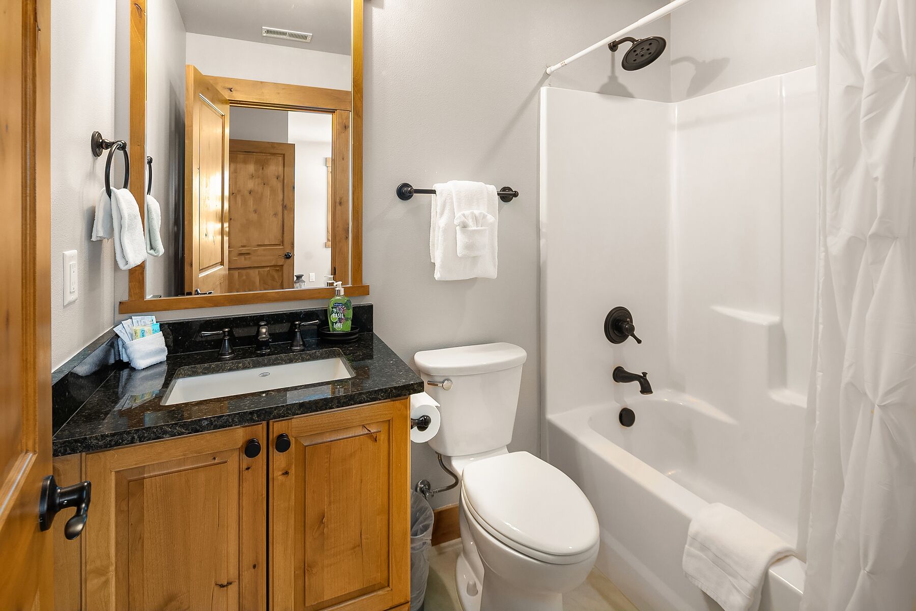 A bathroom with a sink, toilet, and bathtub.