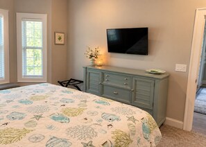 A bedroom with a bed, a dresser, a television, and a window. - Tupelo Bay Unit 712 3 Bedroom 2 Bath Villa (Murrells Inlet)