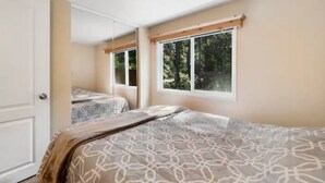 Une chambre à coucher avec un lit, une fenêtre et une porte.