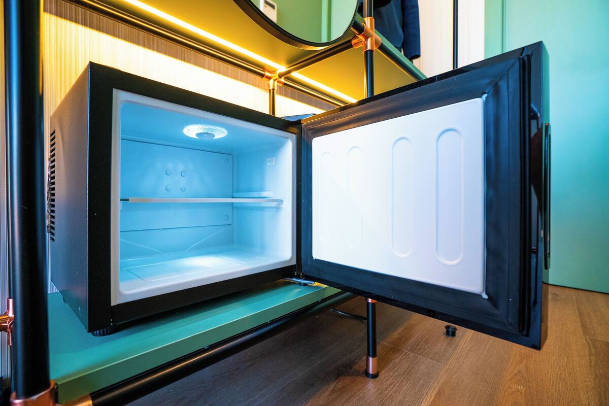 A refrigerator with a glass door, a control panel, and a water dispenser.