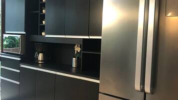 Full-size fridge, microwave, coffee/tea maker, cookware/dishes/utensils