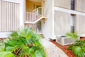 Stunning building with a central staircase and lush greenery.