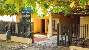 A gated residential property named 'Los Pinos' with a contact number. - Residencial Los Pinos (Puerto Iguazú)
