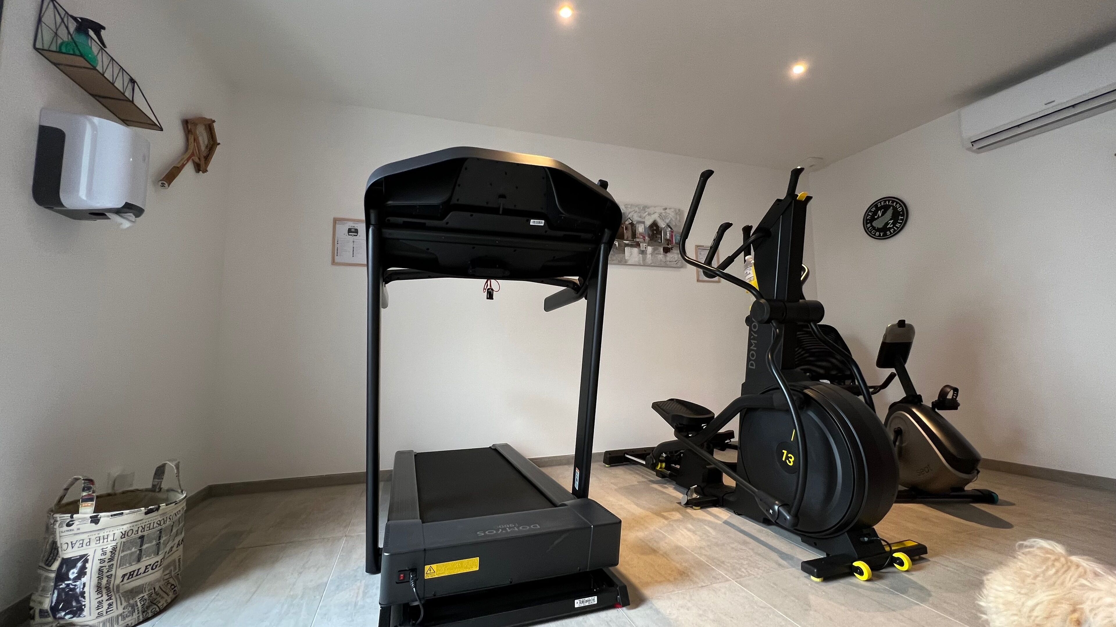 A home gym with a treadmill, an elliptical, and a stationary bike.