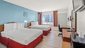 A hotel room with two beds, a desk, a chair, a TV, and a window with curtains. - The Anchor Hotel (Myrtle Beach)