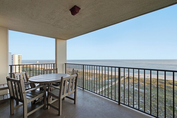 Balcony with table and chairs plus three tall adirondacks - Beachfront 3Br 2 Bath, Sleeps 8 Comfortably - Spectacular View (Orange Beach)