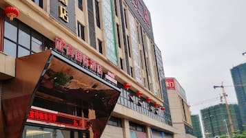 A multi-story building with a prominent entrance and signage.