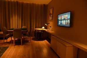 A hotel room with a pool table, a bar area, and a television displaying movie options. - Echarm Hotel (Hong'an Zidong Xincheng) (Hong'an)