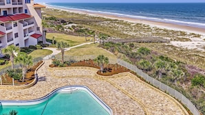 A resort with a swimming pool, beachfront access, and a boardwalk. - Sensational Sandcastles Condo/Oceanfront-Amelia (Fernandina Beach)