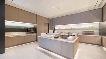 A modern kitchen with a central island, built-in appliances, and a clean, minimalist design.
