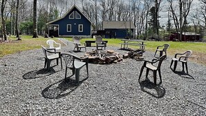 A rustic cabin with a fire pit and outdoor seating. - Black Bear Retreat by Taylor Made Deep Creek (McHenry)