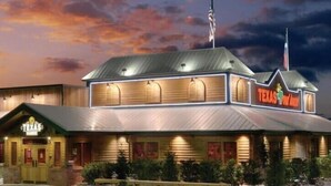A building with a sign reading "TEXAS IN THE MIDWEST". - Hidden Gem Retreat | 2BR Basement |Near Mall of GA (Buford)