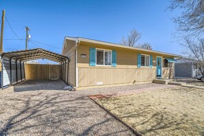 A single-story house with a garage, a covered patio, and a fenced backyard. - 3bdfamily Retreat Near COS Airport & Fort Carson (Colorado Springs)