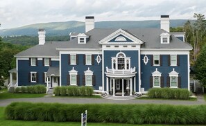 A large, two-story house with a central balcony, surrounded by well-maintained hedges and a driveway. - The Kemble- Built by a US Secretary of State in Lenox (Lenox)