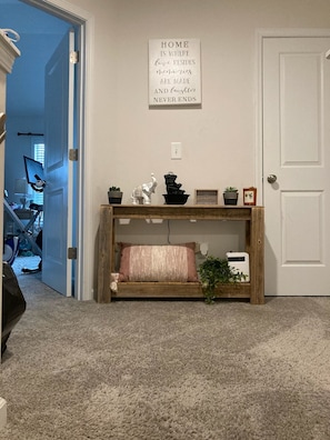 Enter a warm and inviting space with a cozy bench and a heartfelt message above.