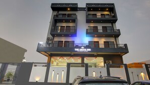 A multi-story hotel with balconies and a sign reading "The Amaya Inn". - Treebo Amaya Inn Sector 72 (Noida)