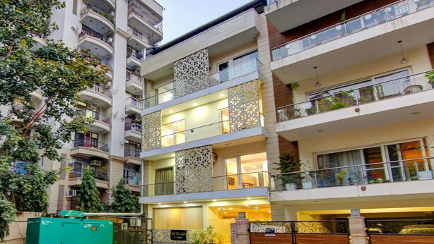 A multi-story hotel with balconies, a decorative facade, and a sign indicating a 'No Parking' zone. - Treebo Sai Village Gold Souk - Sec 43 (Gurugram)
