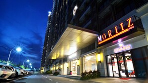 A hotel named Moritz Inn with a modern facade and a visible entrance.