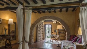 A room with a bed, a desk, a chair, a lamp, and a bookshelf. - Beautiful villa in the heart of Mugello. Pool, jacuzzi, sauna. (Borgo San Lorenzo)