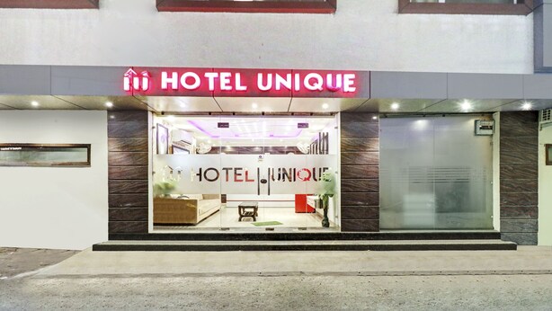 A hotel entrance with a prominent sign reading "HOTEL UNIQUE". - Itsy Hotels Unique (Amritsar)