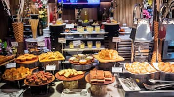 A buffet with various food items and utensils.