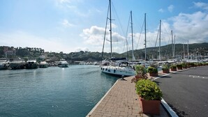 A marina with boats docked along a paved waterfront, a clear sky, and a hilly landscape in the background. - Bed and Breakfast 'Gocce Di Cristallo' with Sea View, Wi-Fi and Air Conditioning (Varazze)