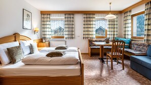 A bedroom with a bed, a desk, a chair, and a sofa. - Holiday Apartment 'Ciasa Alfred' with Mountain View, Wi-Fi & Balcony (La Villa)
