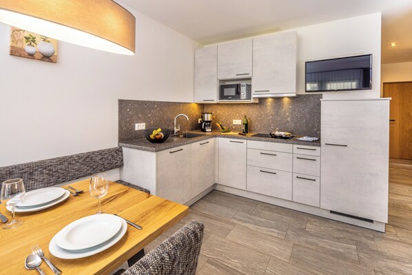 Fridge, stovetop, dishwasher, coffee/tea maker