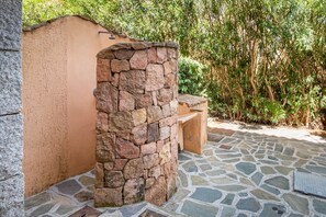 A stone pillar, a wooden bench, and a stone-tiled floor.
