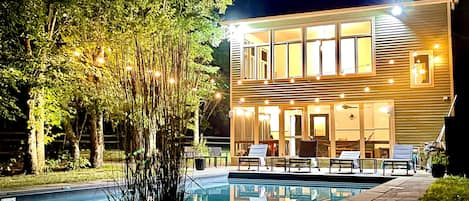 The pool area at night by the porch