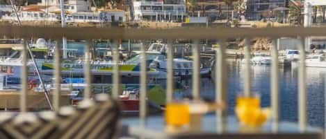 A marina with boats docked, a chair, and a table with yellow items.