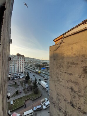 A high-rise building overlooking a busy highway with multiple lanes and vehicles.