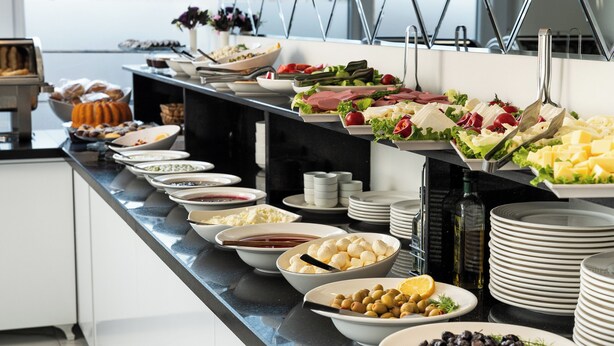 A buffet with various food items and a sign hanging from the ceiling. - Şimal Hotel (Rize)