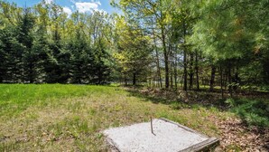 A natural outdoor area with a wooden deck and a sandy patch. - Carmel Sunday by Taylor Made Deep Creek (Swanton)
