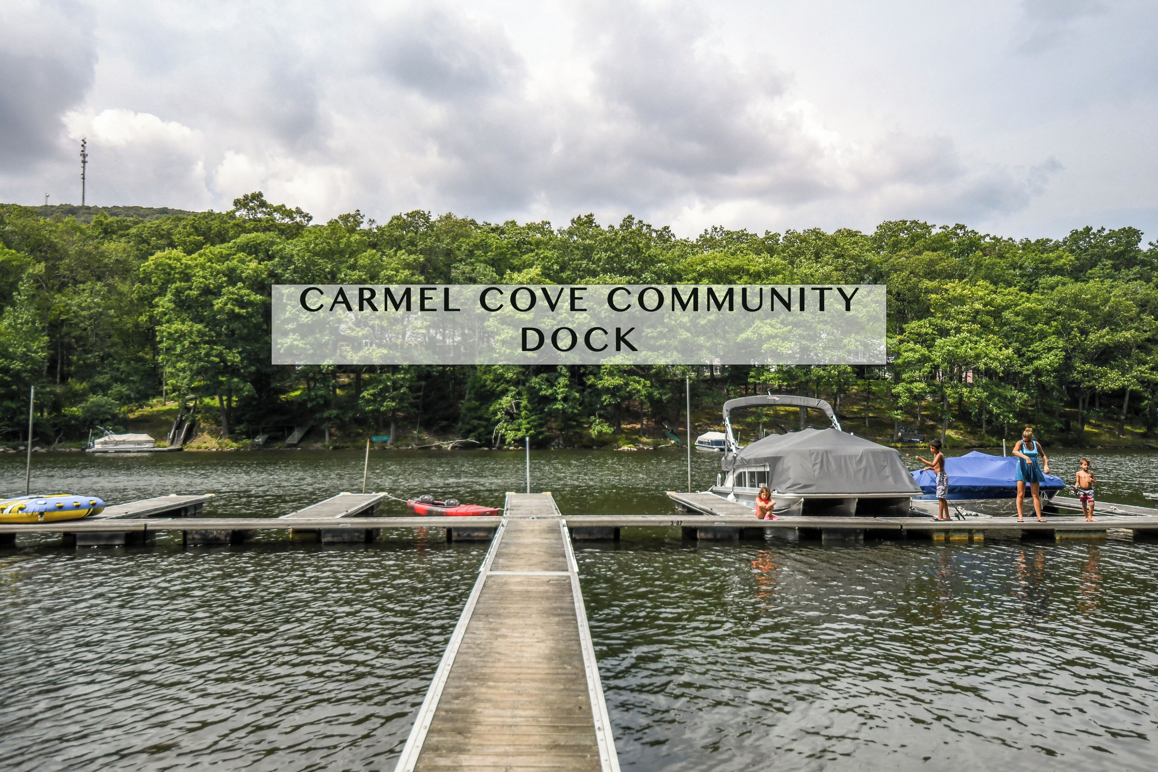 A dock at the Carmel Cove Community Dock with boats and a covered area.