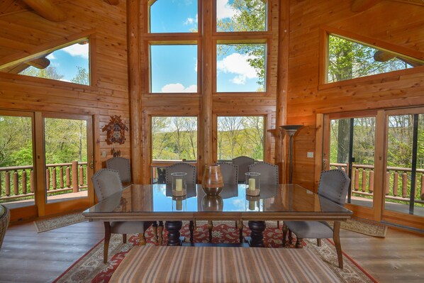 Enjoy meals with family and friends at the large table, surrounded by a view of the lush greenery.