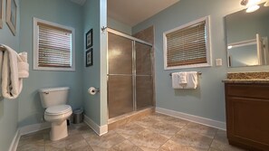 Bathtub, hair dryer, towels, toilet paper