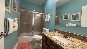 Bathtub, hair dryer, towels, toilet paper