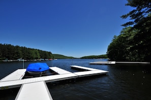 A calm lake with docked boats and a clear blue sky. - Celebration at Deep Creek by Taylor Made Deep Creek (Oakland)