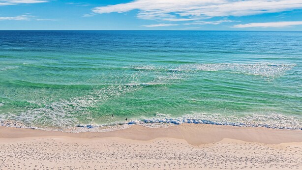 A beach with clear turquoise water and a sandy shore. - Aegean #332 - Gulf-Front Views, Relaxing Amenities (Destin)