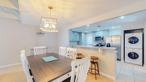 A modern kitchen with white cabinets, a built-in microwave, and a stainless steel refrigerator. - Two Bedroom Villa Steps from Robert Trent Jones Golf Course! (Hilton Head Island)