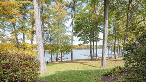 A serene lakeside park with tall trees, a grassy area, and a dock extending into the water. - Four Hooppole South G6 by Taylor Made Deep Creek (Oakland)